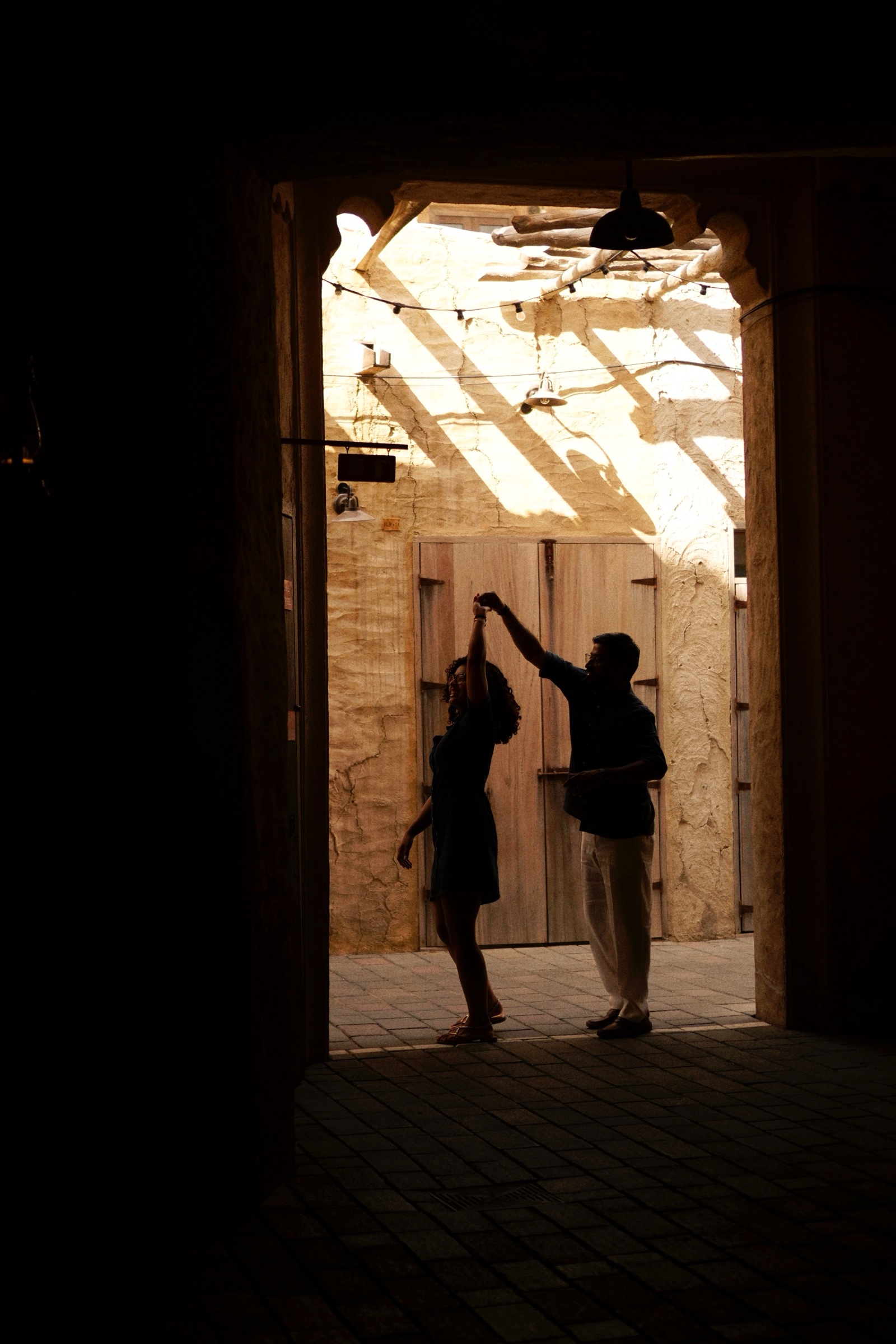 Couple silhouetted in a sunlit doorway