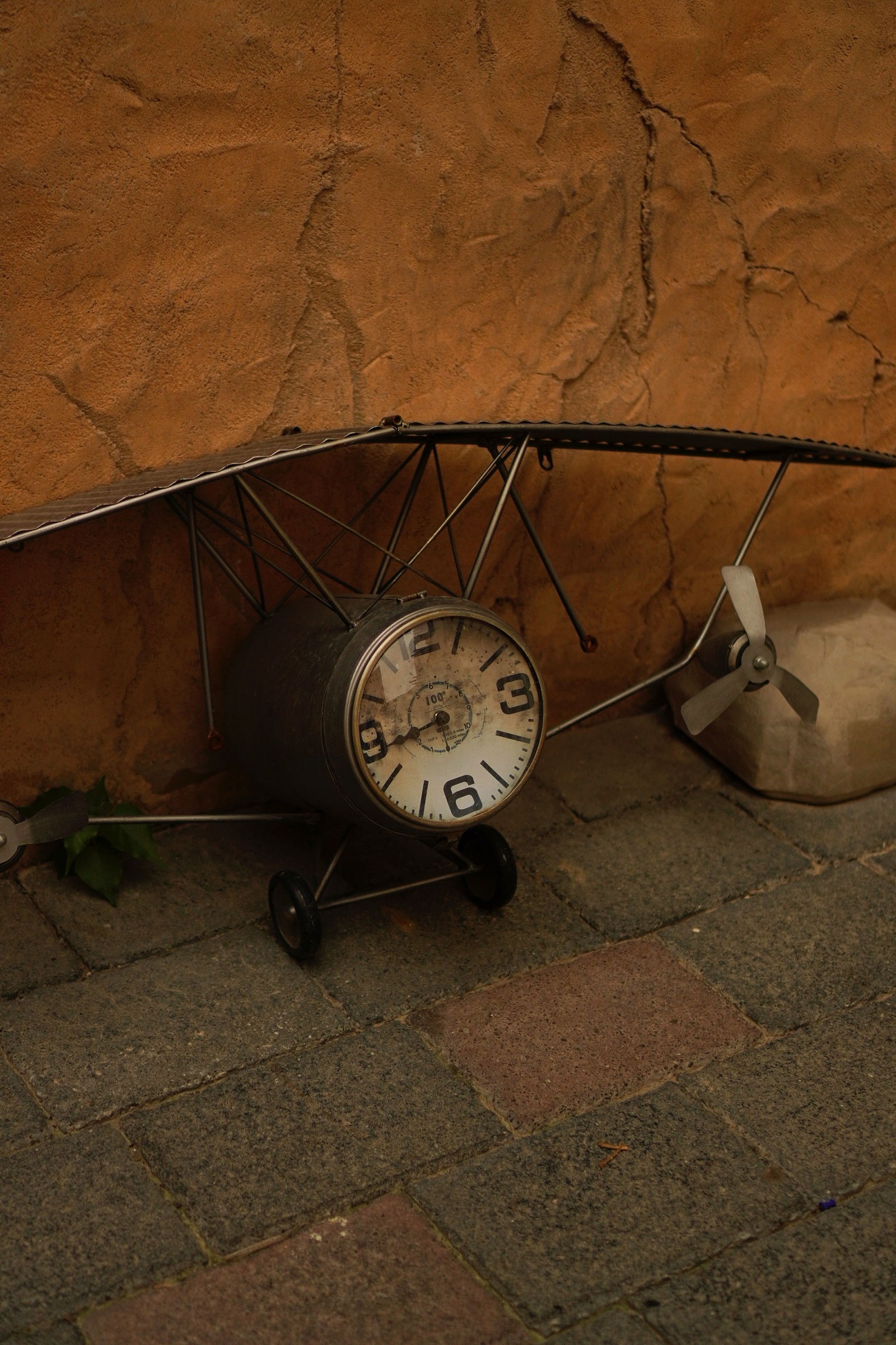 Vintage model airplane clock detail at Al Seef
