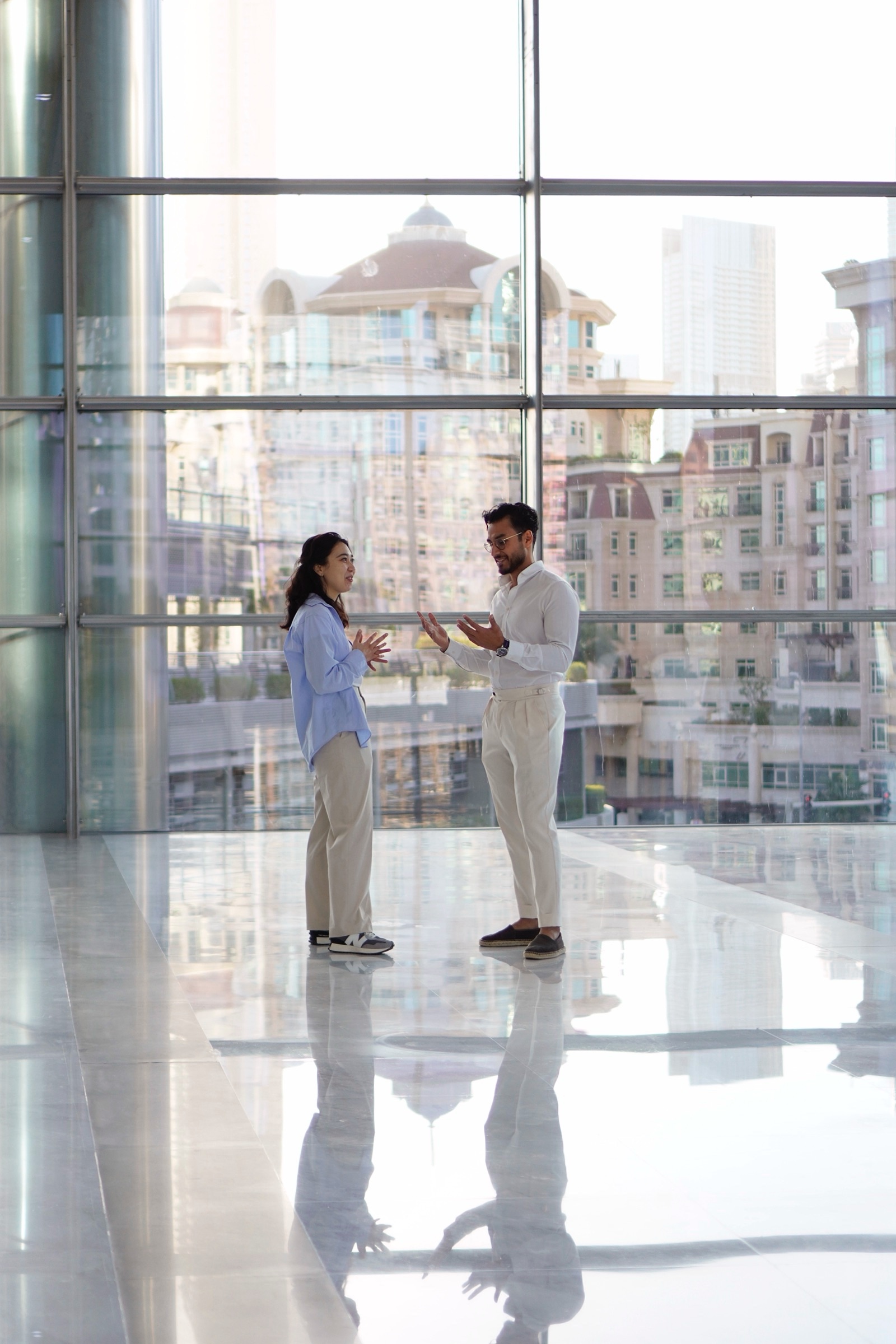Colleagues meeting by a floor-to-ceiling window
