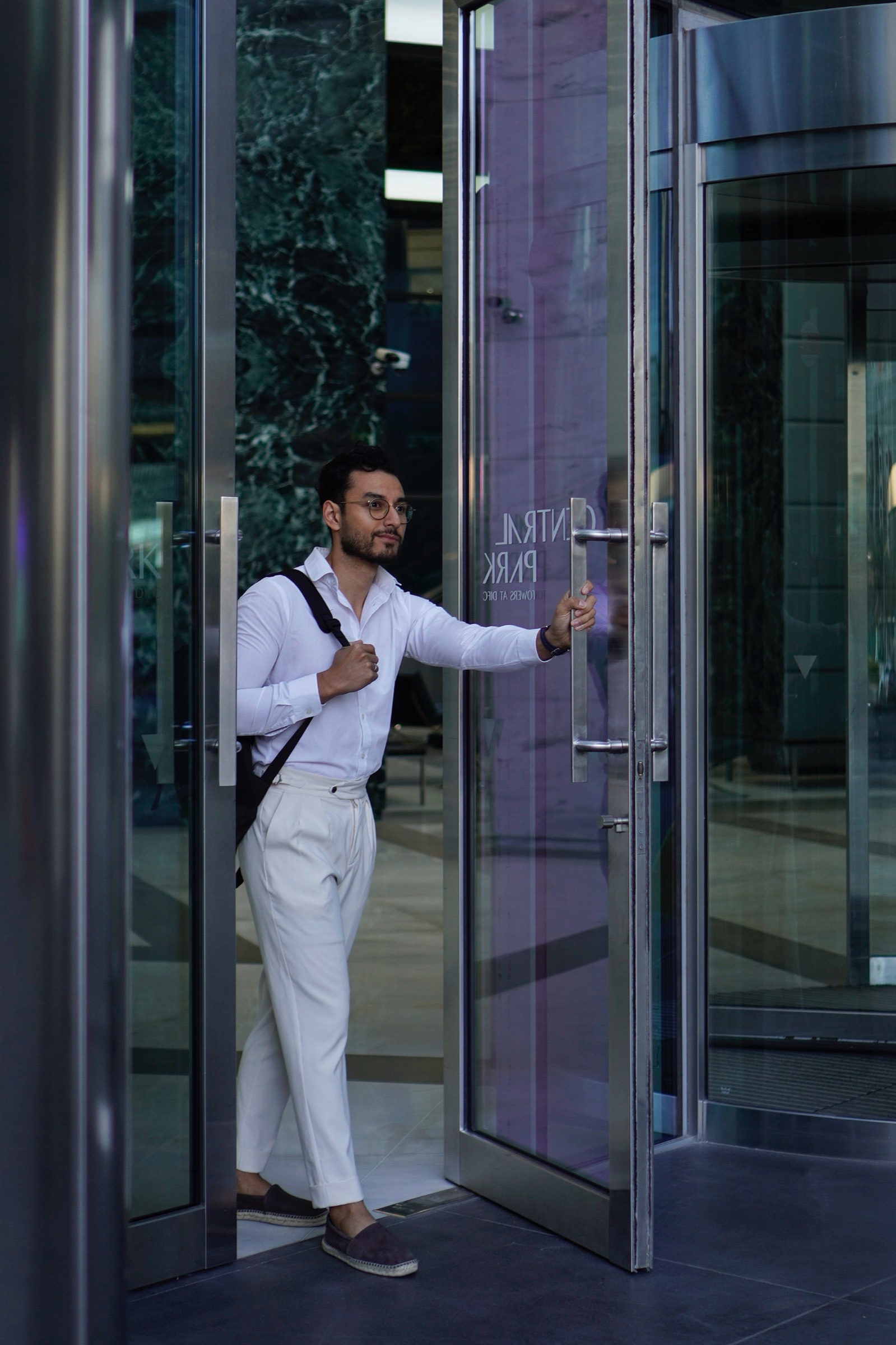 Businessman pushing through a glass door