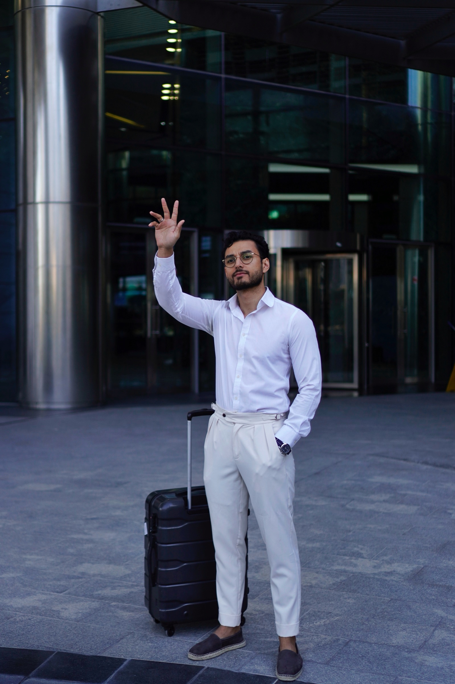 Businessman greeting someone in a tower plaza