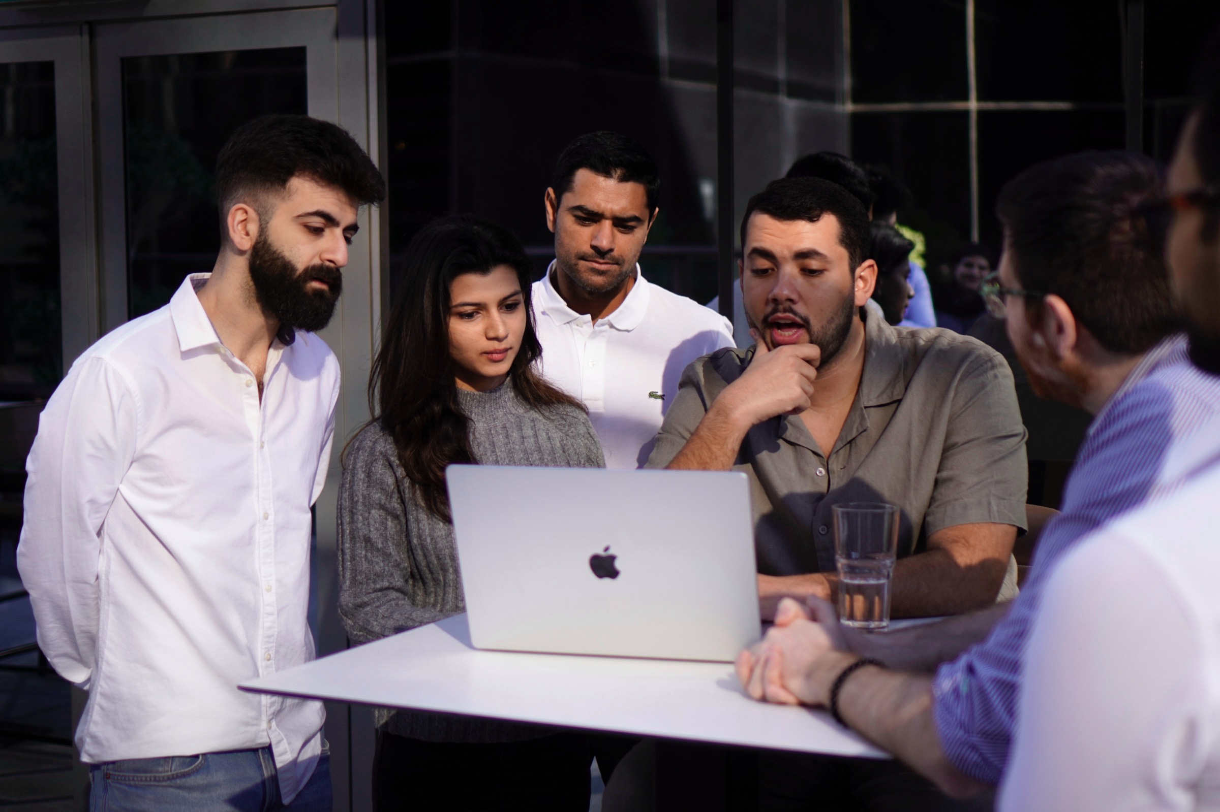 Group of colleagues working at a laptop