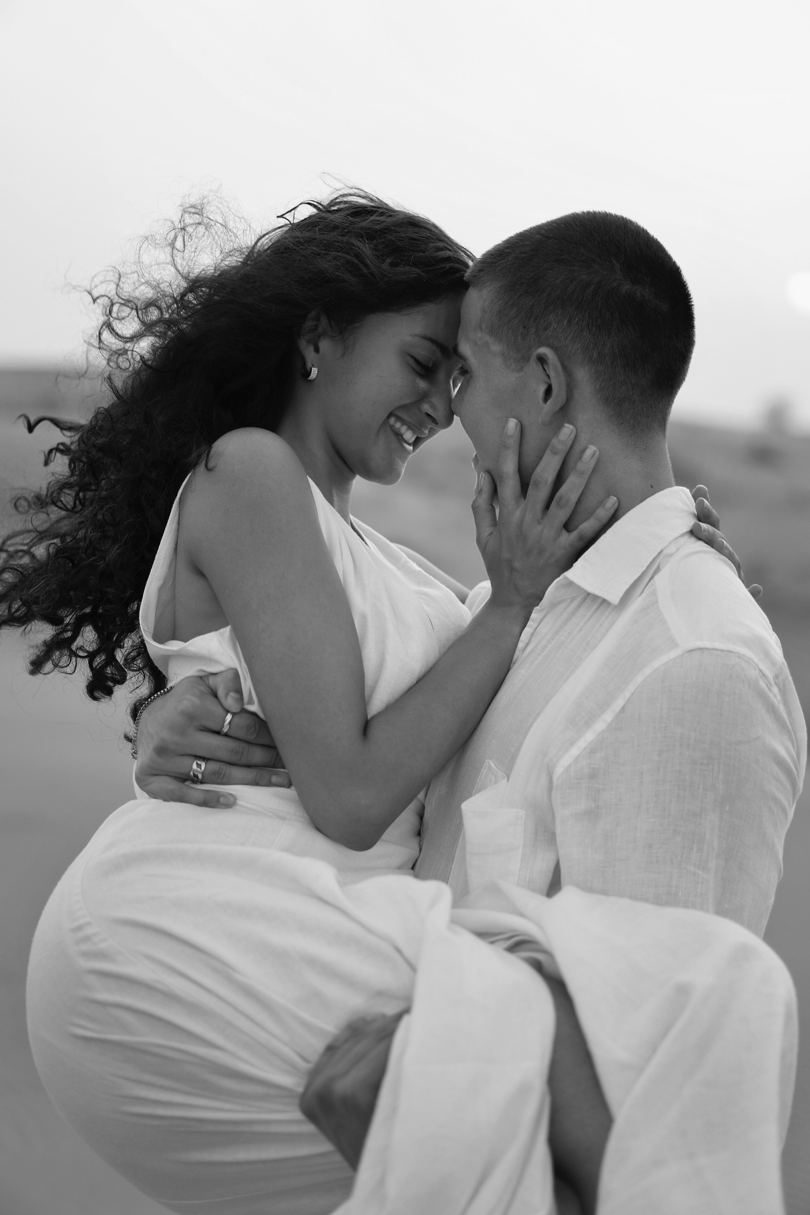 Couple in a close desert embrace, black and white