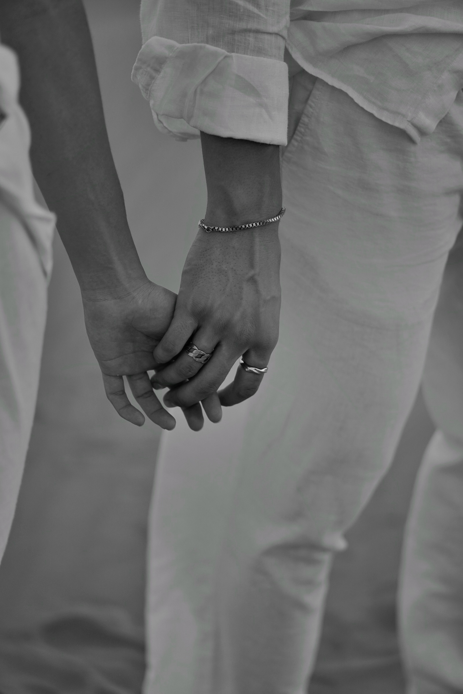 Held hands detail in the desert, black and white