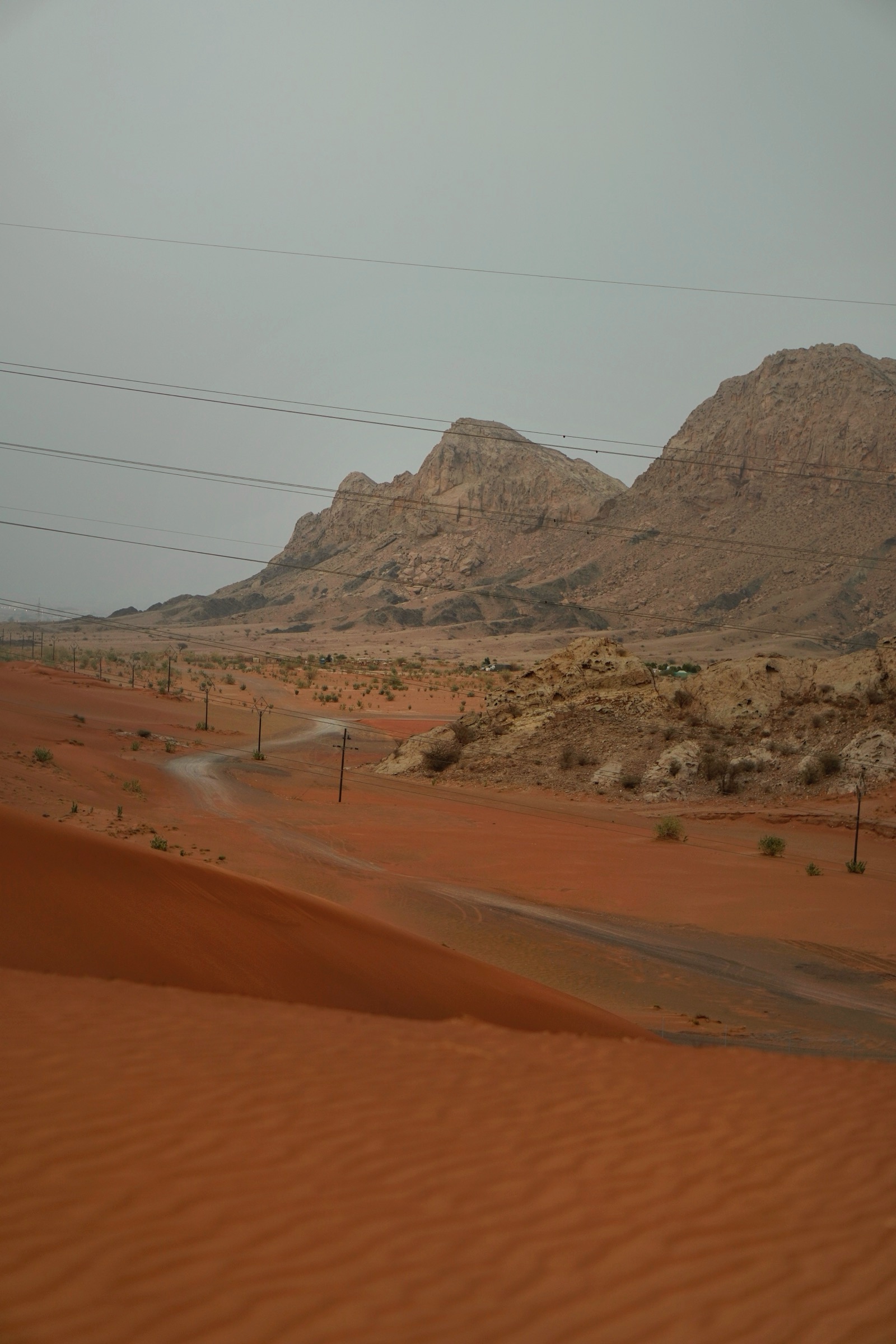 Desert road winding toward a distant mountain