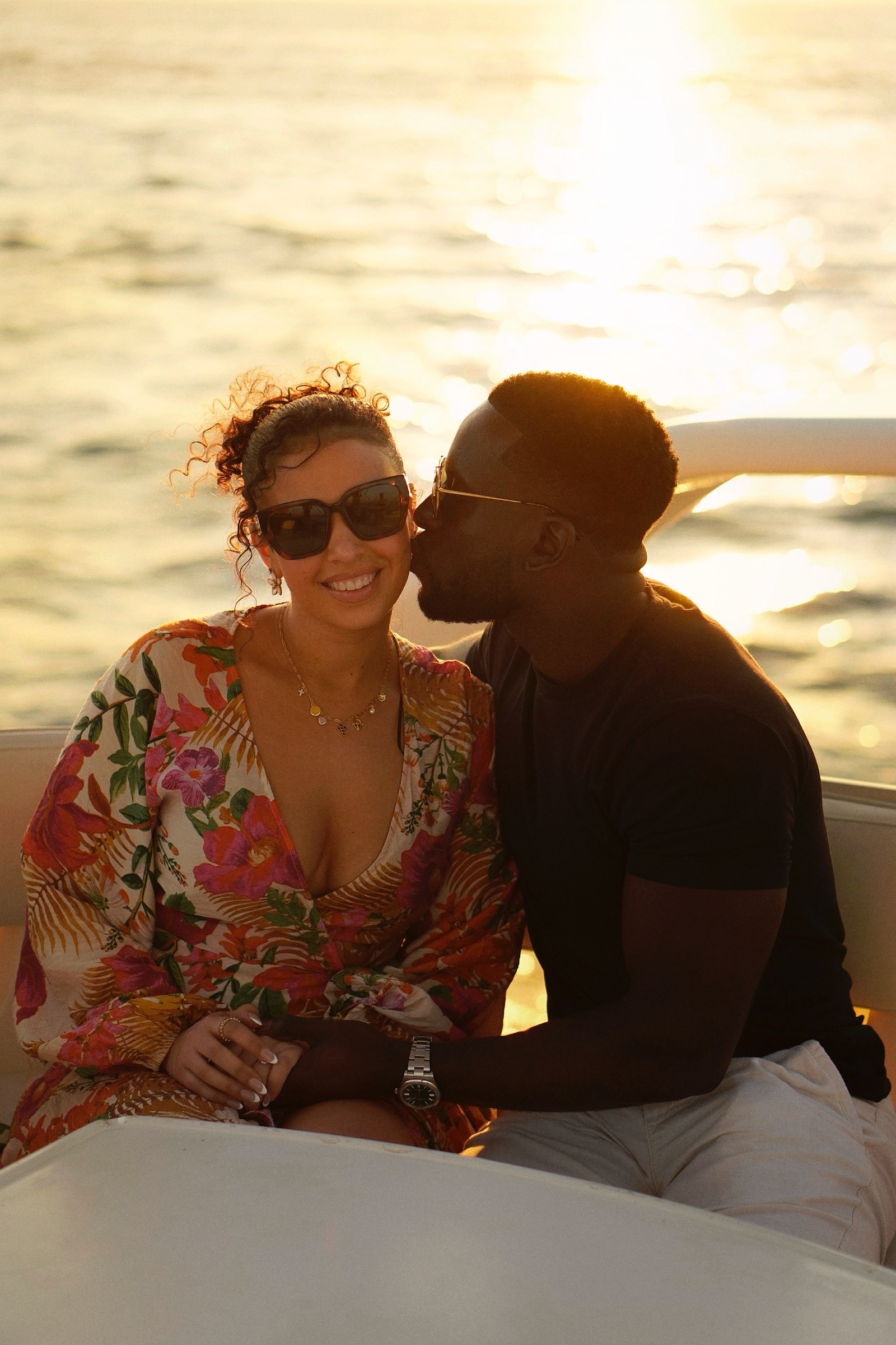 Couple kissing at sunset on a yacht