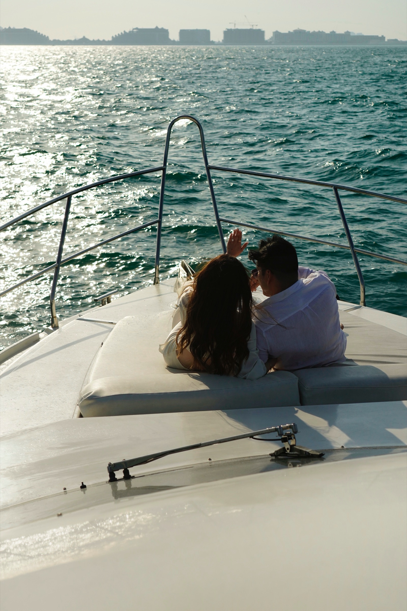 Couple reclining together looking out to sea