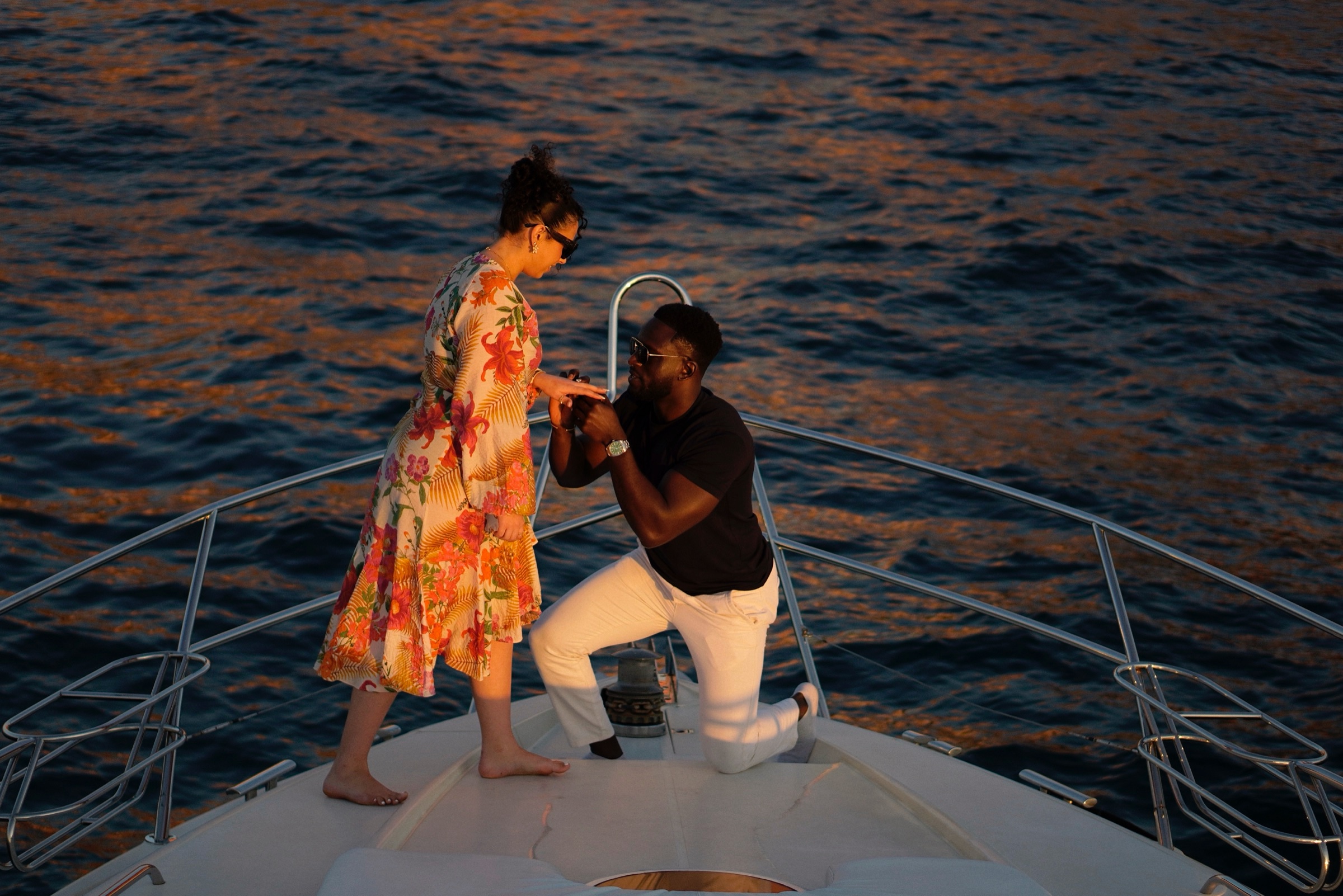Woman embracing her partner at the bow of a yacht