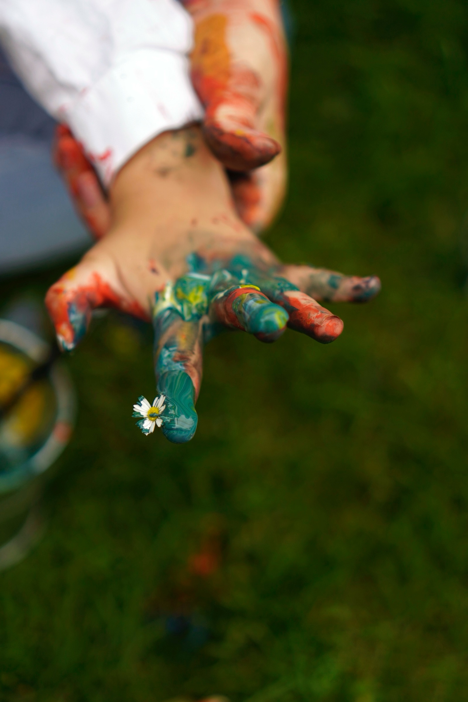 Close-up of a child's paint-covered hand
