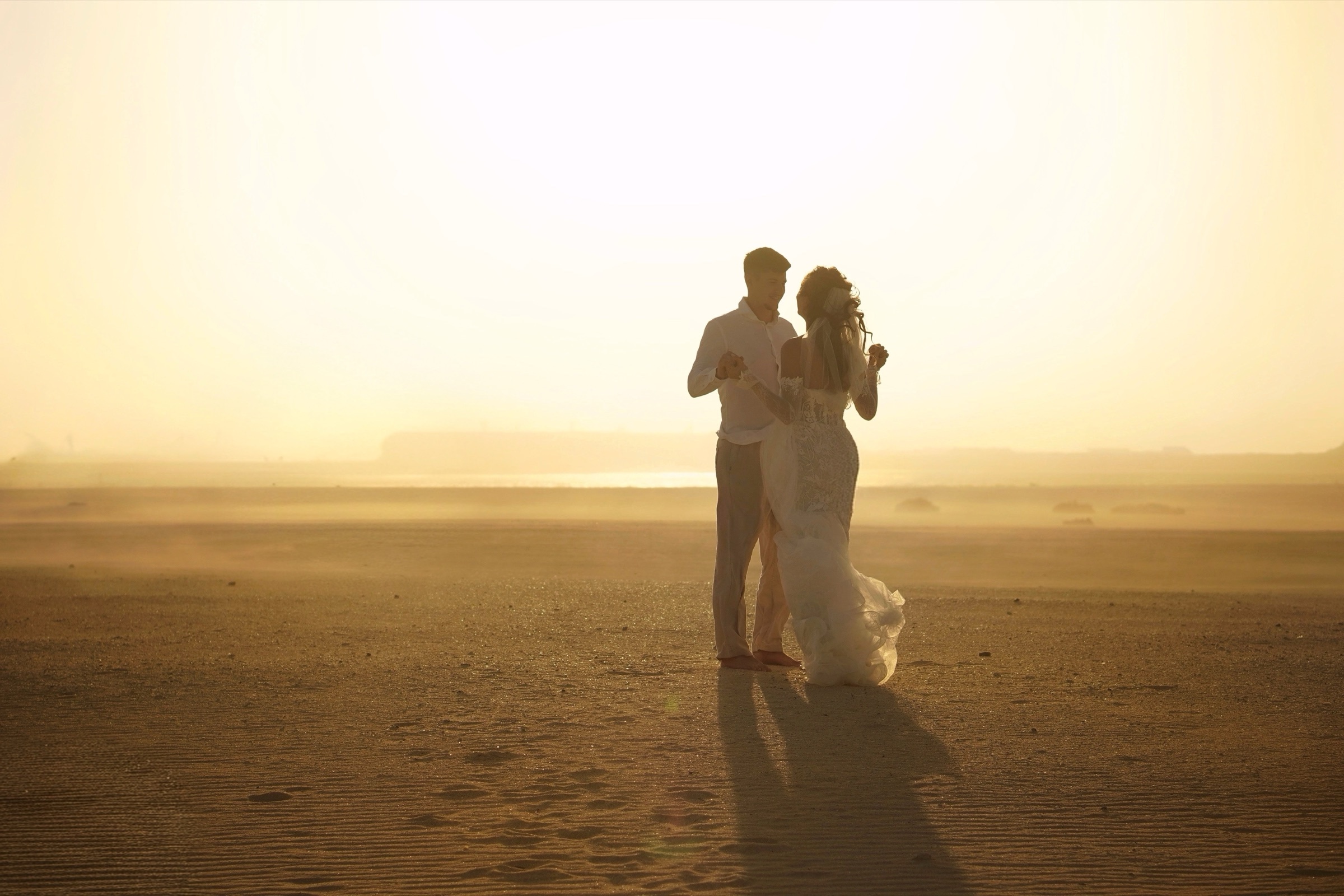 Couple embracing in a warm golden haze