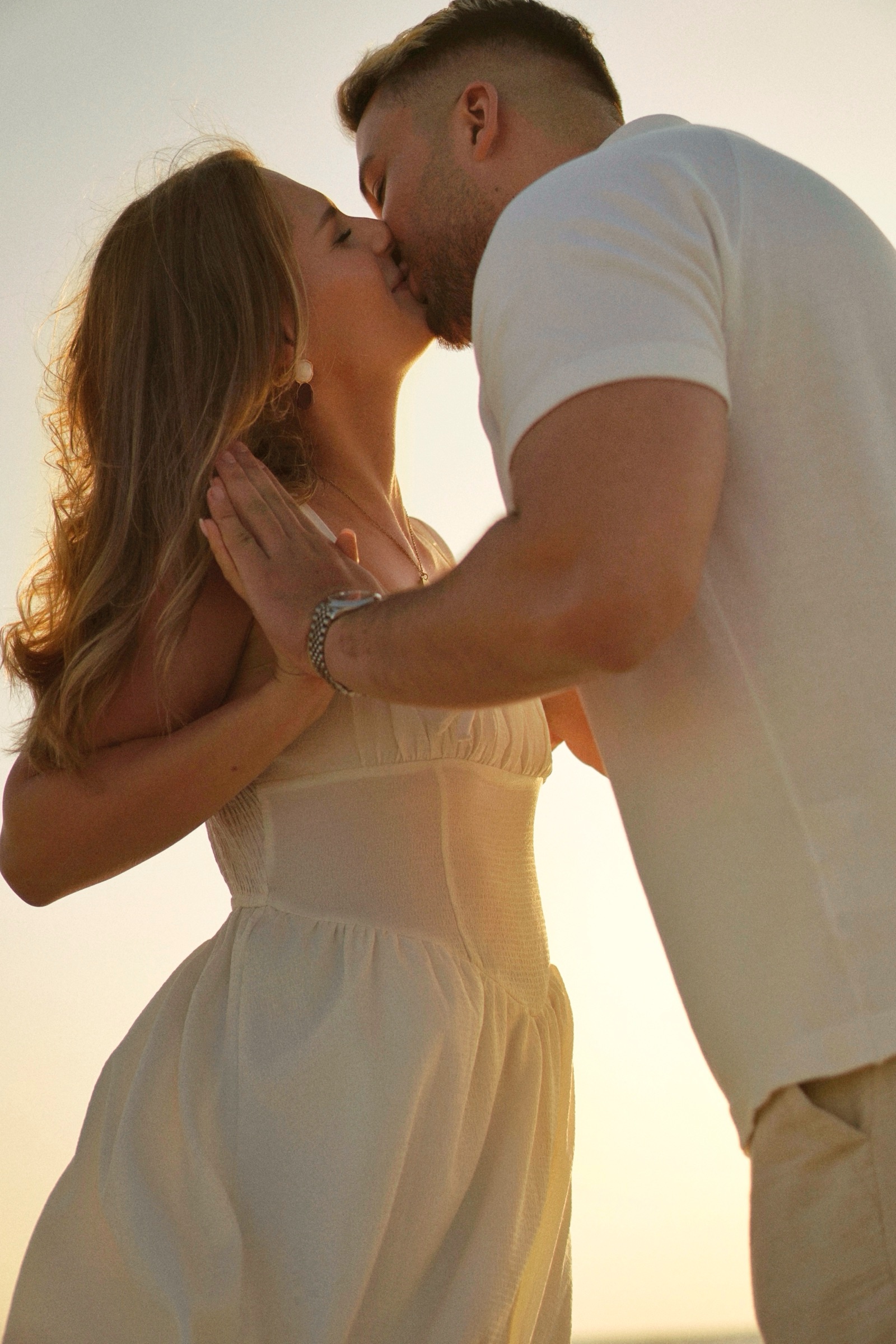 Couple kissing at beach sunset