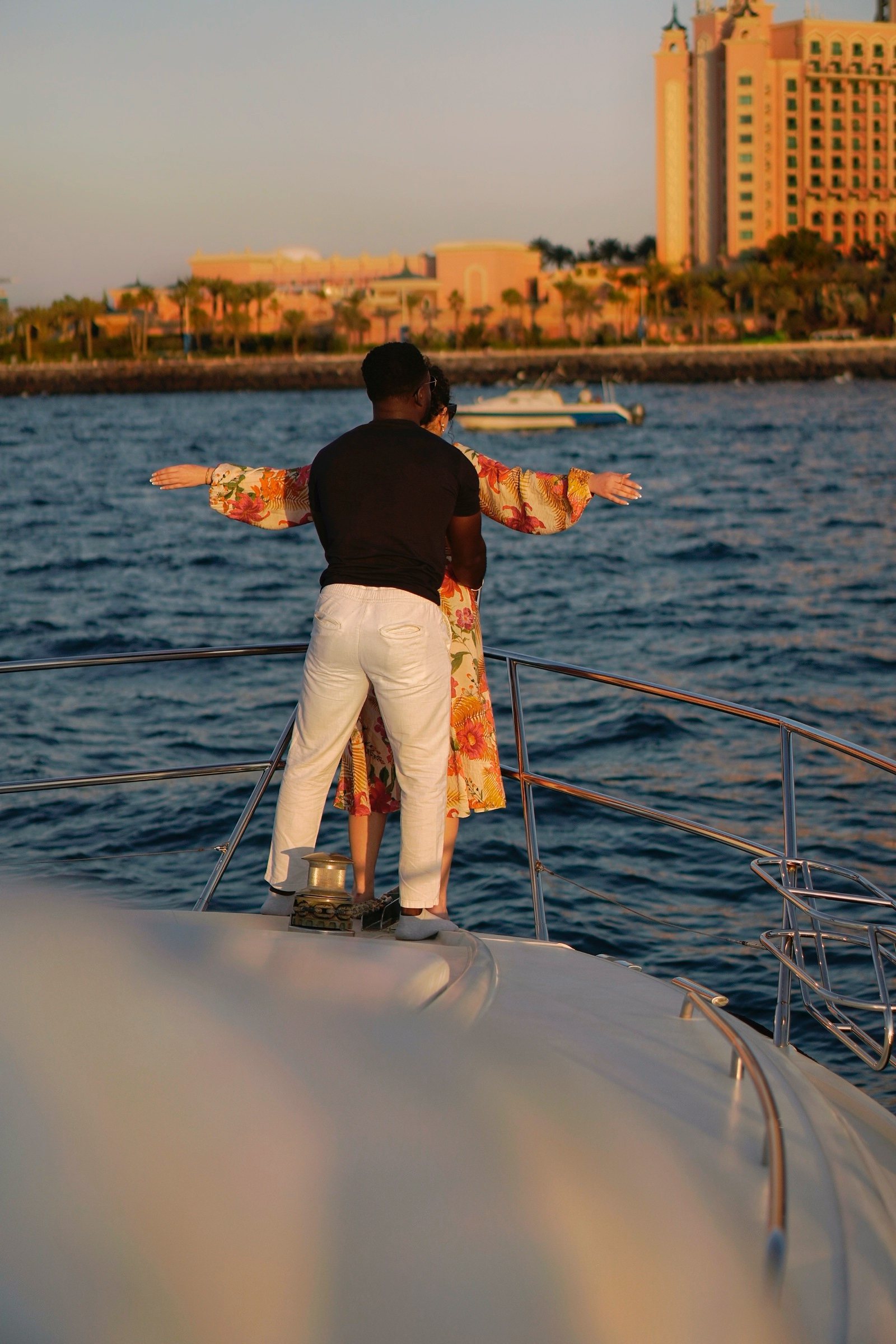 Couple on yacht with Atlantis in background