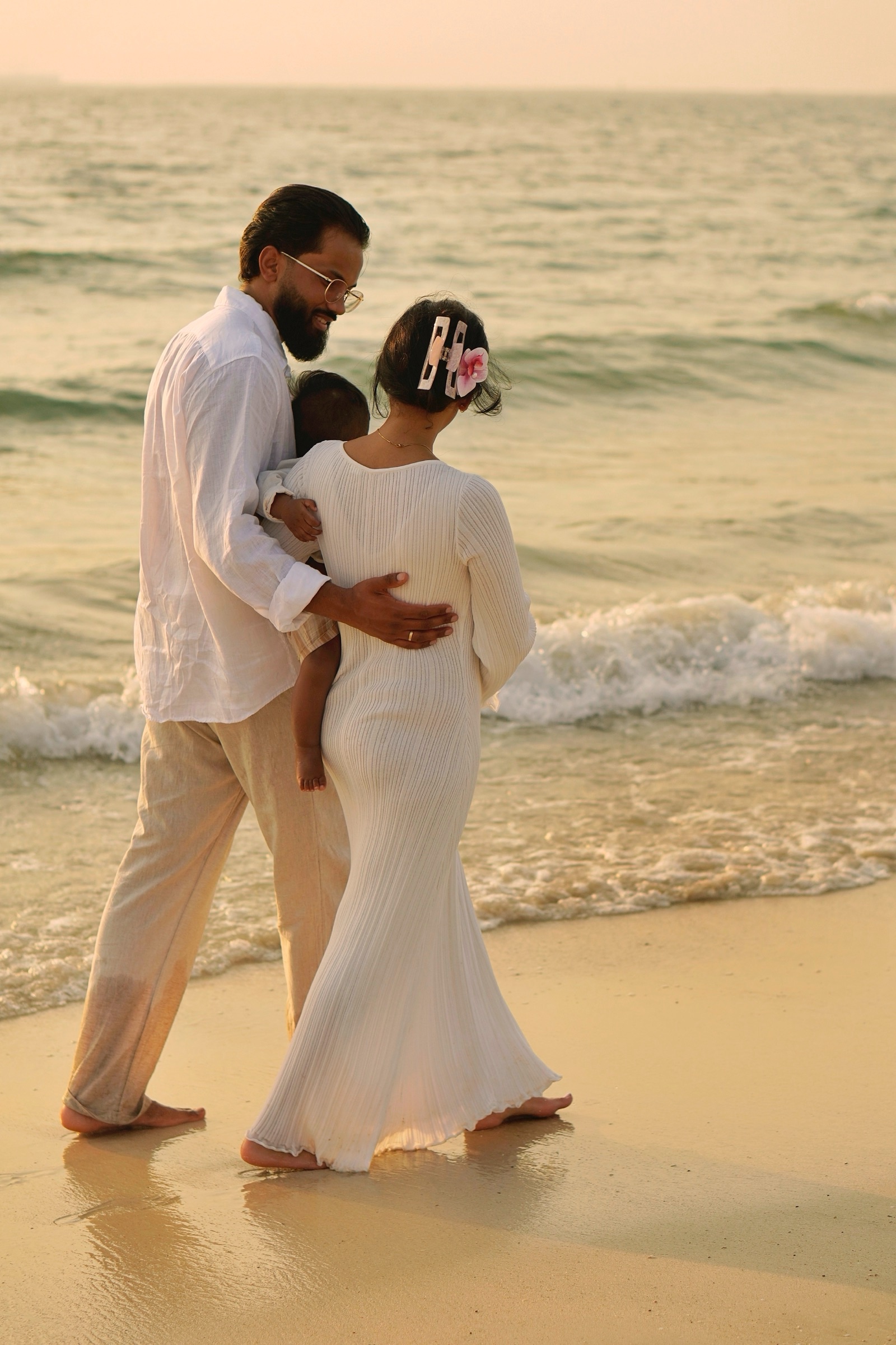 Couple dancing in the waves in white