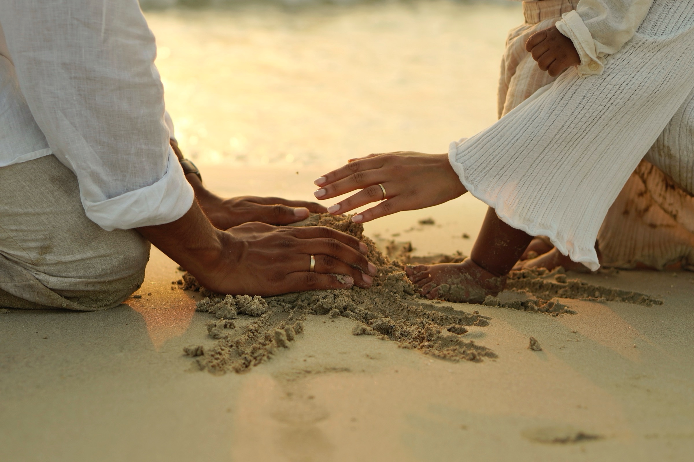 Father and child playing in the sand